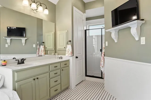 a bathroom with a double vanity sink a mirror and a shower