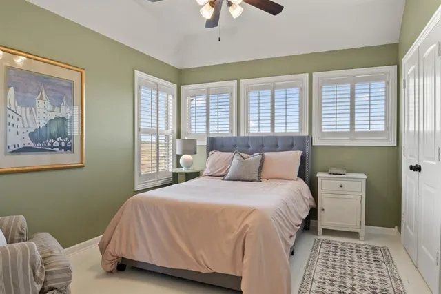 a bedroom with a bed and a painting on the wall