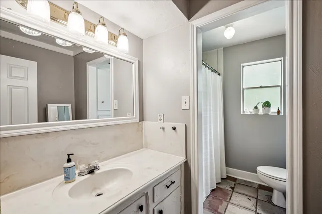 a bathroom with a sink toilet and shower