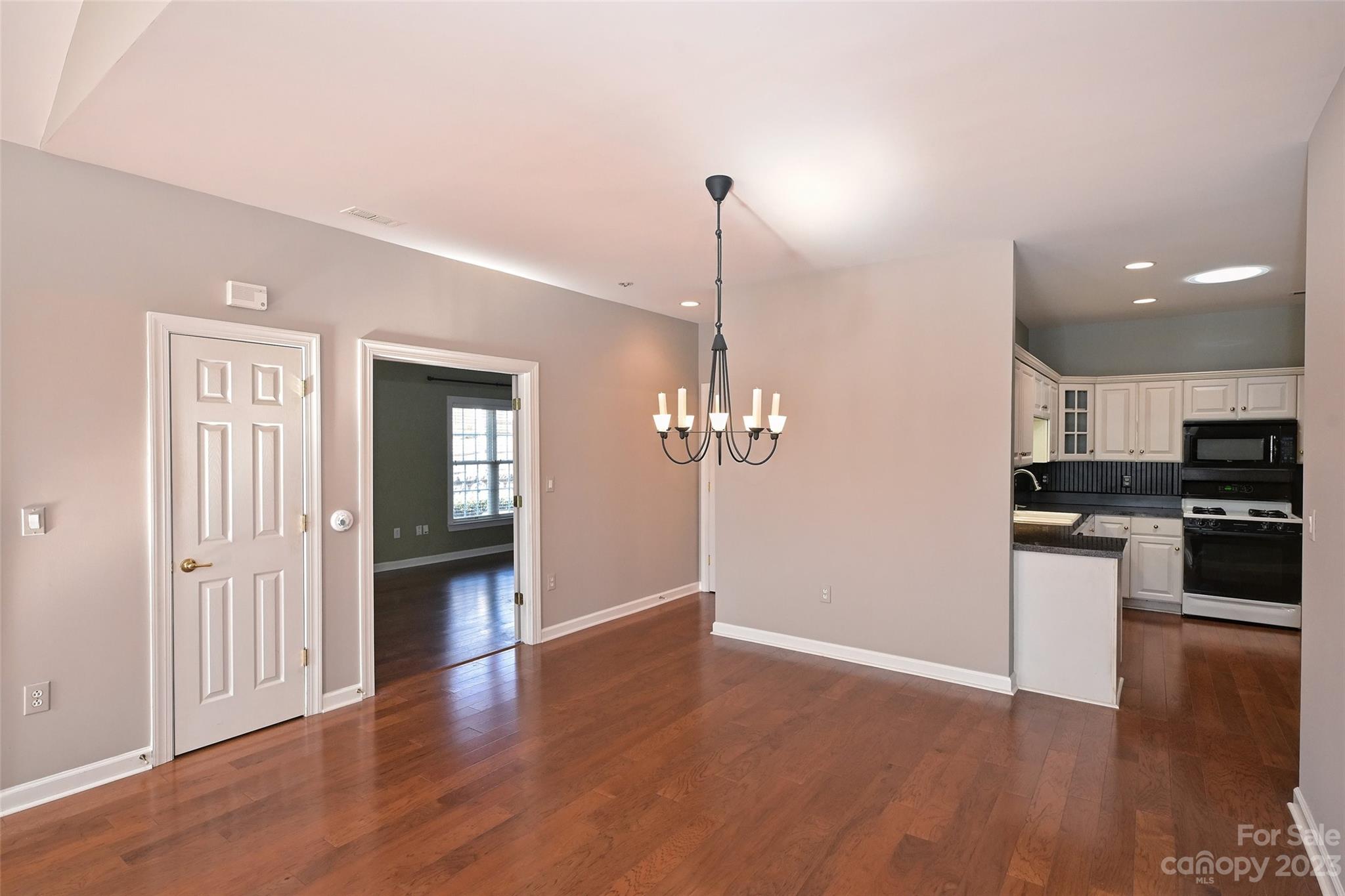 8445 Windsor Ridge Drive Charlotte, NC 28277 - Photo 11 of 26 a view of a kitchen with a sink wooden floor and a living room