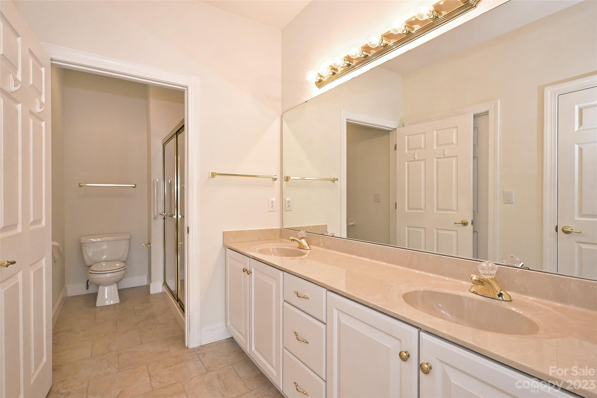 8445 Windsor Ridge Drive Charlotte, NC 28277 - Photo 19 of 26 a spacious bathroom with a granite countertop sink a toilet and a shower