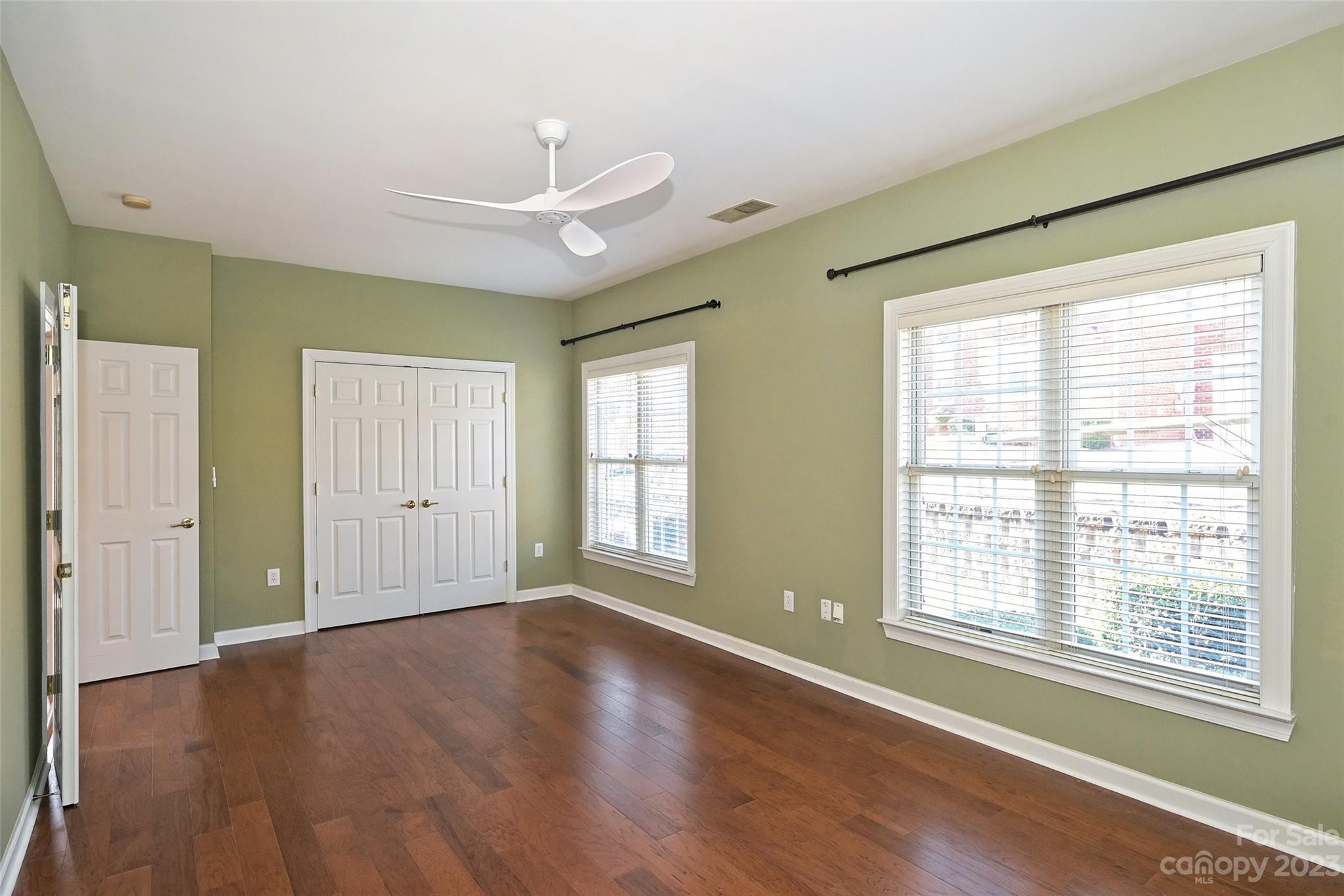 8445 Windsor Ridge Drive Charlotte, NC 28277 - Photo 23 of 26 a view of an empty room with a window and wooden floor
