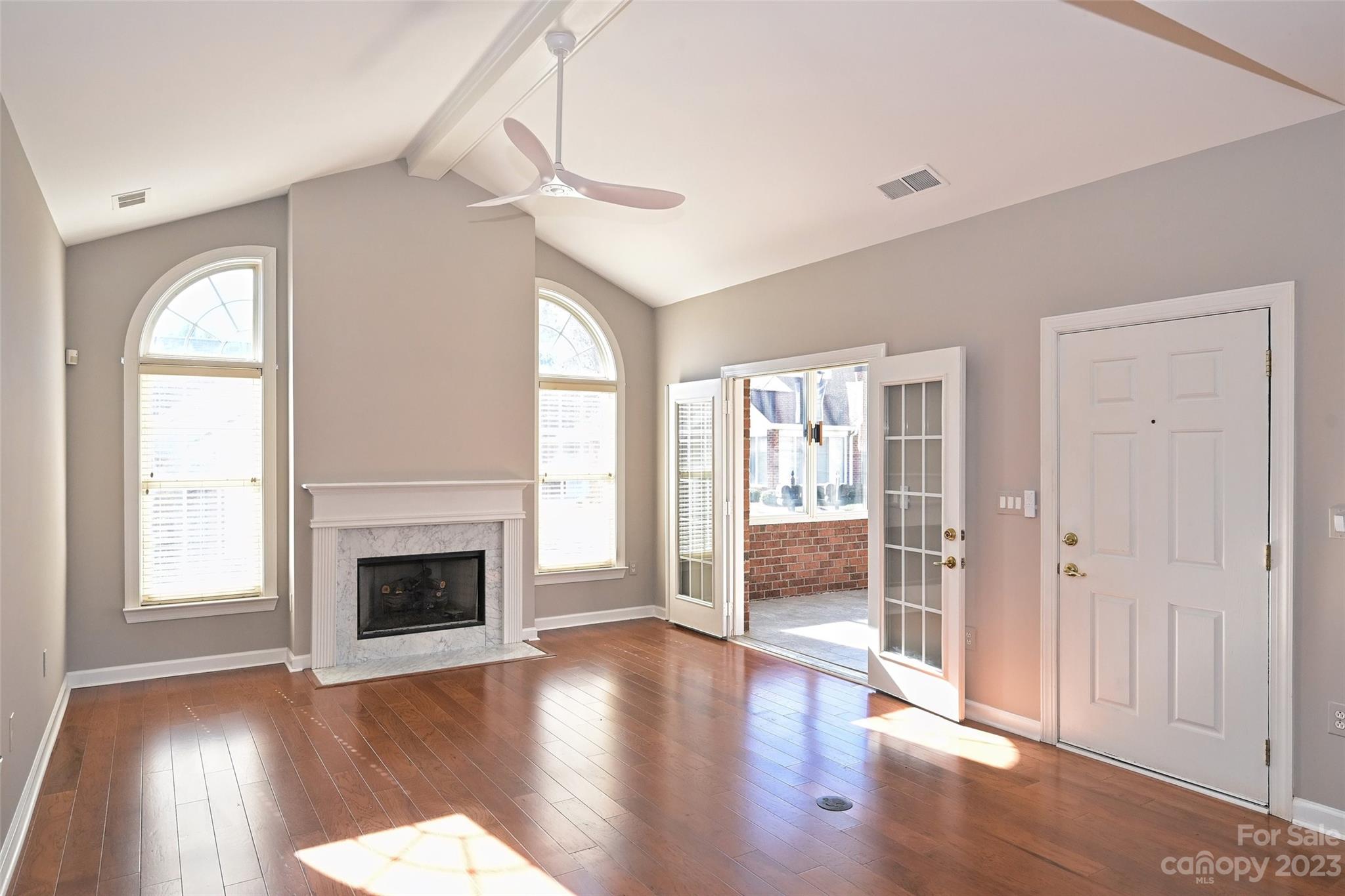 8445 Windsor Ridge Drive Charlotte, NC 28277 - Photo 6 of 26 a view of a livingroom with wooden floor a fireplace and window