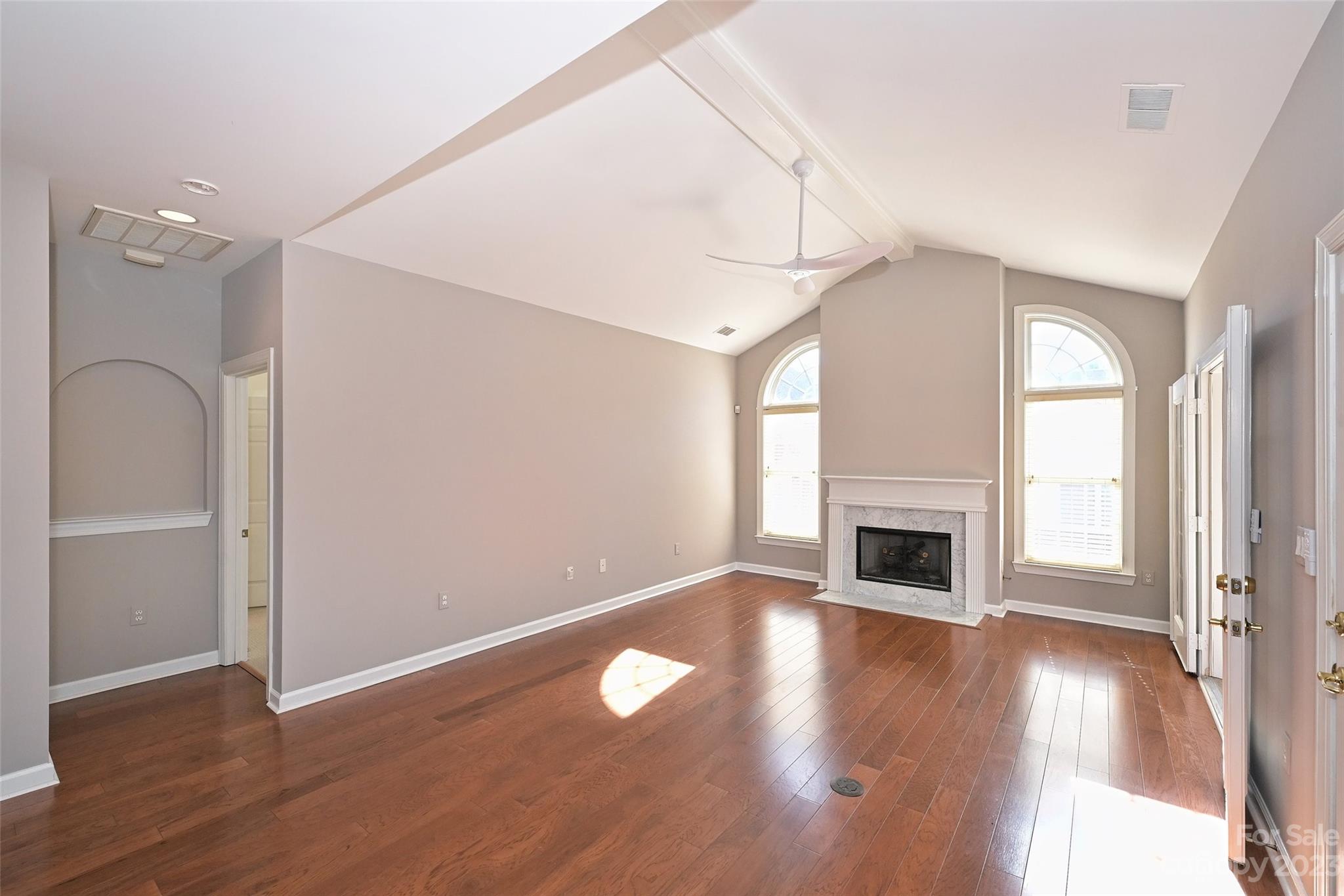 8445 Windsor Ridge Drive Charlotte, NC 28277 - Photo 7 of 26 a view of empty room with wooden floor and fireplace