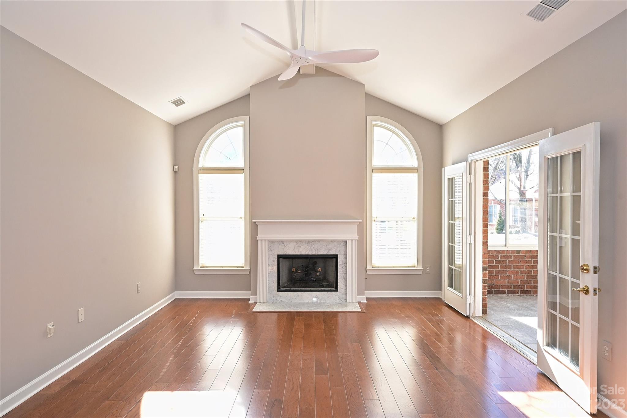 8445 Windsor Ridge Drive Charlotte, NC 28277 - Photo 8 of 26 a view of an empty room with wooden floor fireplace and a window