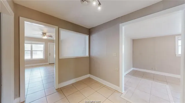 an empty room with windows and closet