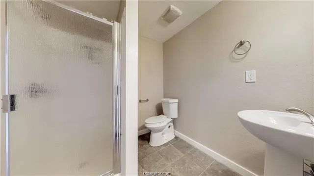 a bathroom with a toilet sink and a shower