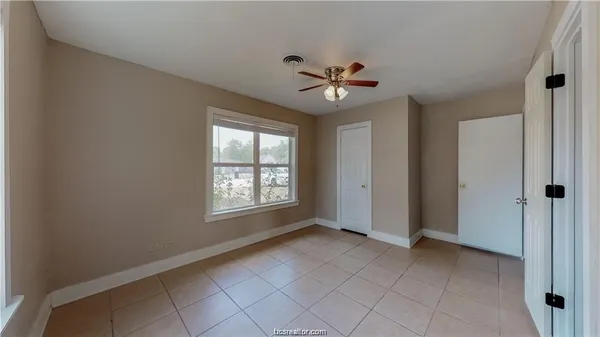 a view of an empty room with a window
