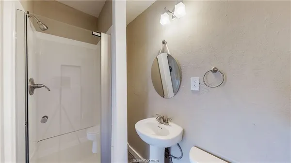 a bathroom with a sink a mirror and shower