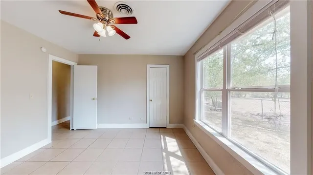 a view of an empty room with a window