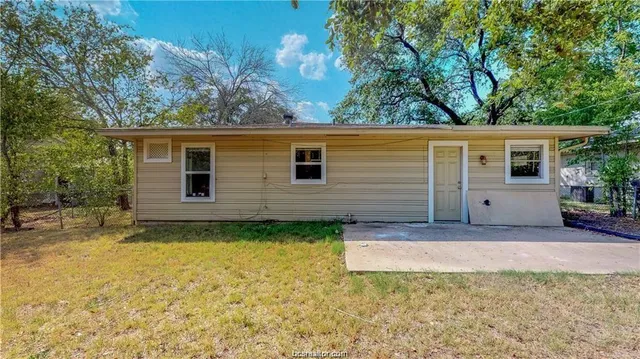 a view of a backyard with wooden fence
