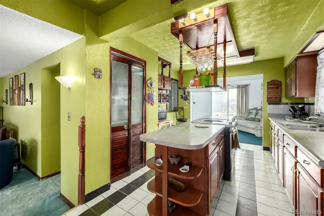 a kitchen with stainless steel appliances granite countertop a sink and a refrigerator