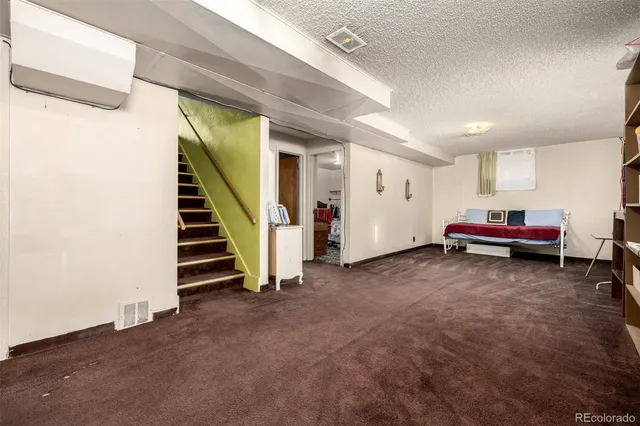 a view of a livingroom with furniture and staircase