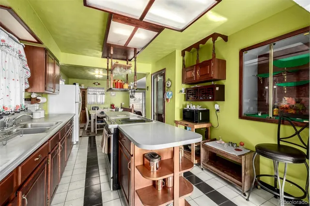 a view of a kitchen with stainless steel appliances granite countertop a sink and a refrigerator