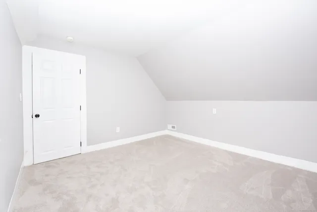 a car parked in front of white house