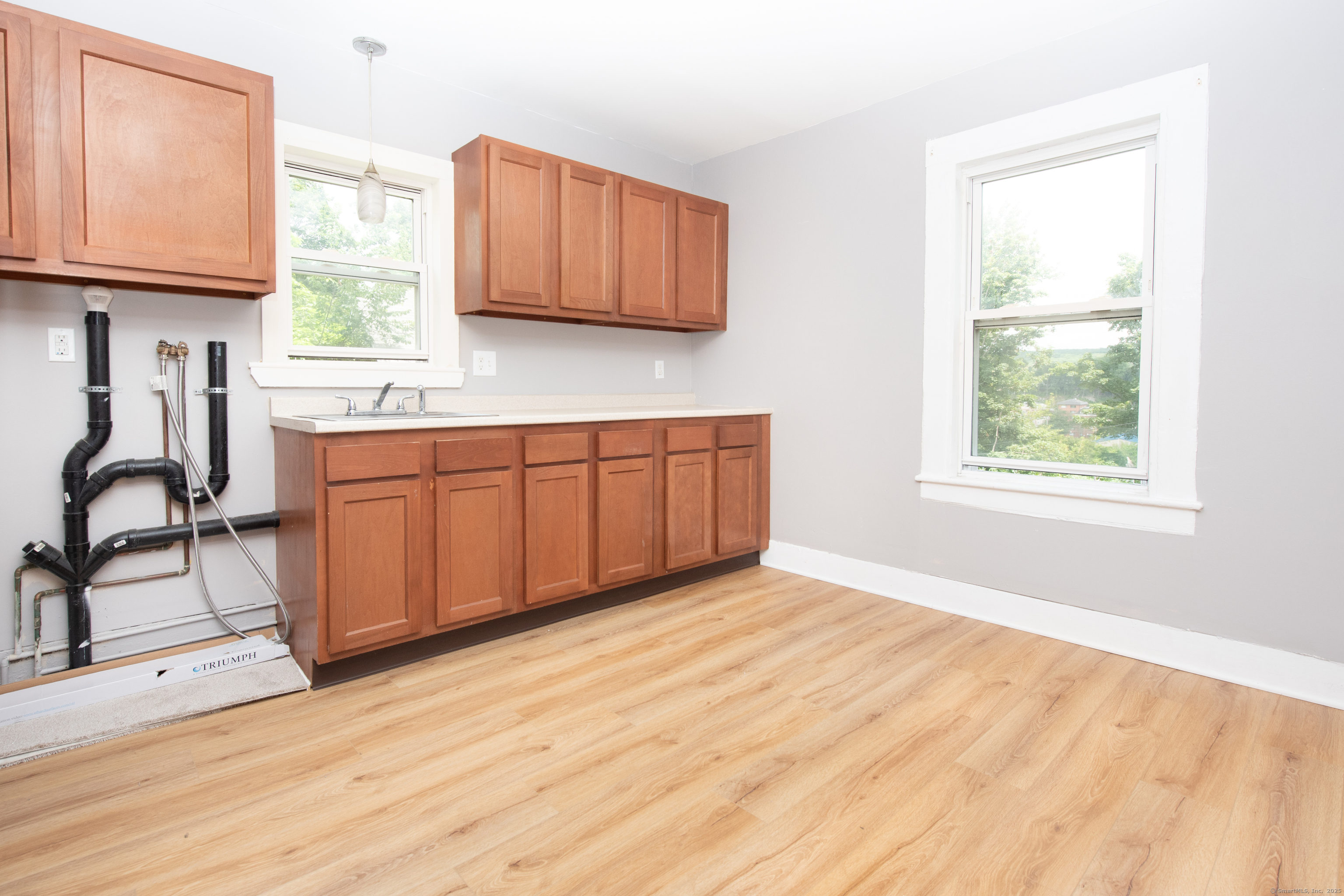 6 Crescent Street Ansonia, CT 06401 - Photo 4 of 25 a kitchen with stainless steel appliances granite countertop a stove a sink and a window