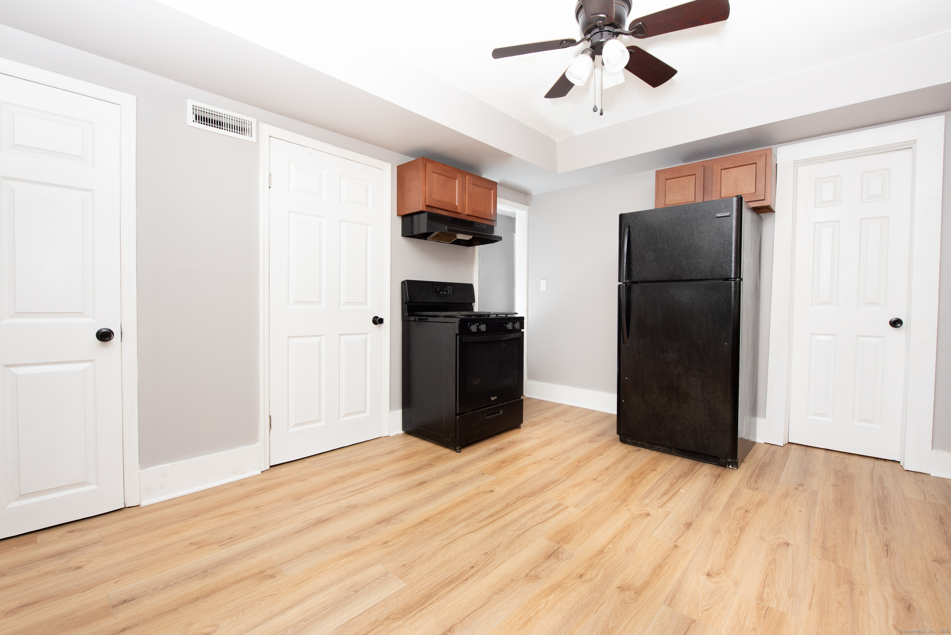 6 Crescent Street Ansonia, CT 06401 - Photo 5 of 25 a view of a kitchen with refrigerator and wooden floor