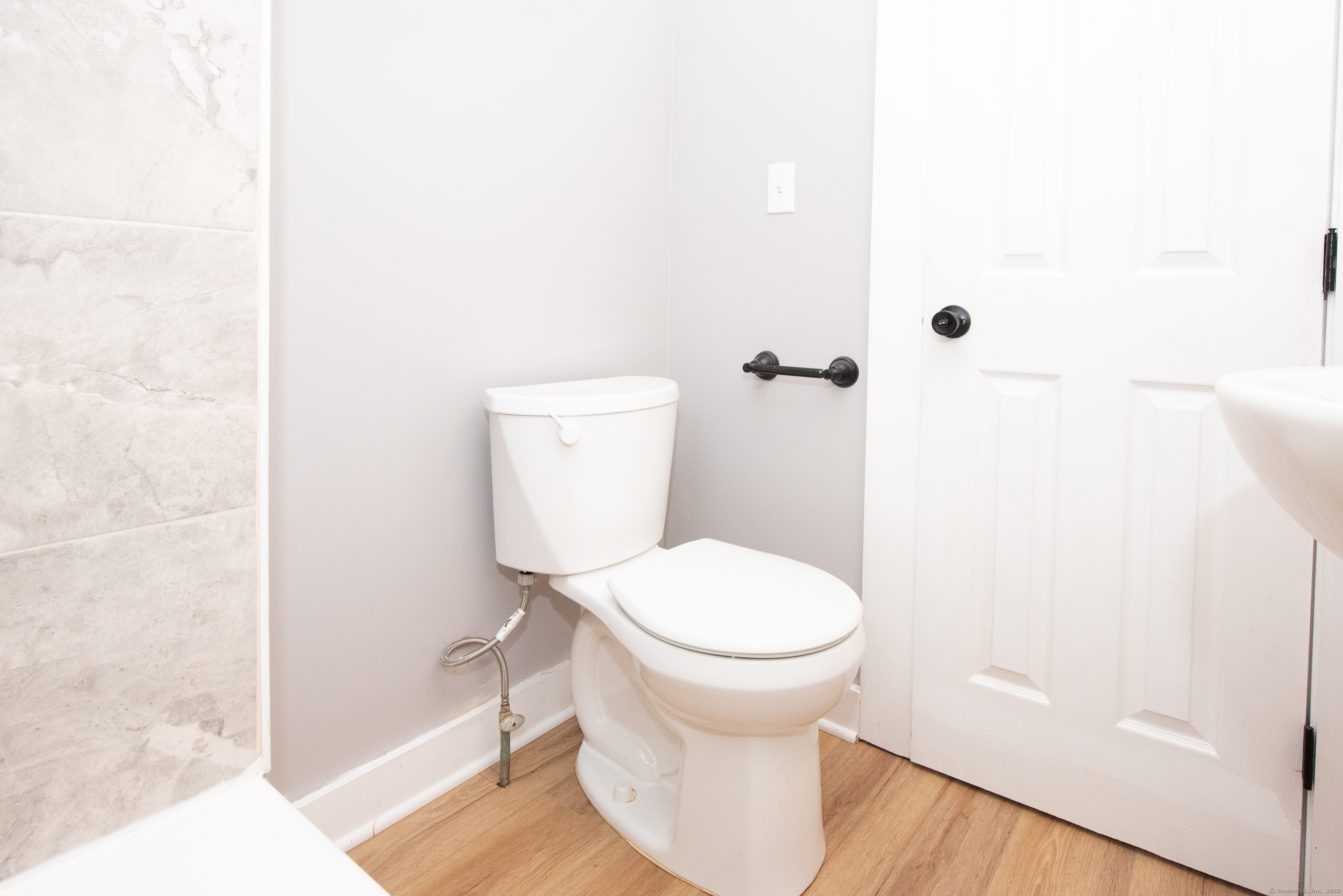 6 Crescent Street Ansonia, CT 06401 - Photo 7 of 25 a white toilet sitting next to a shower