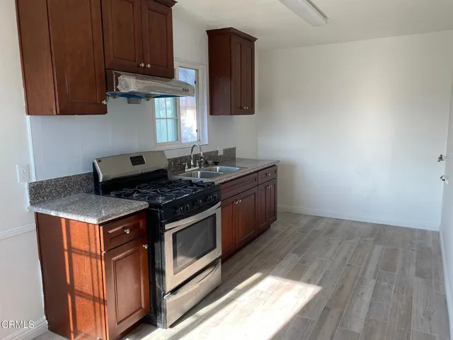 a stove top oven sitting inside of a kitchen