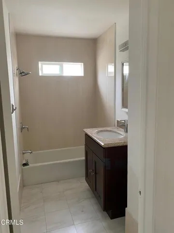 a bathroom with a sink a vanity and a mirror