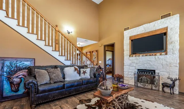 a living room with furniture fireplace and a flat screen tv