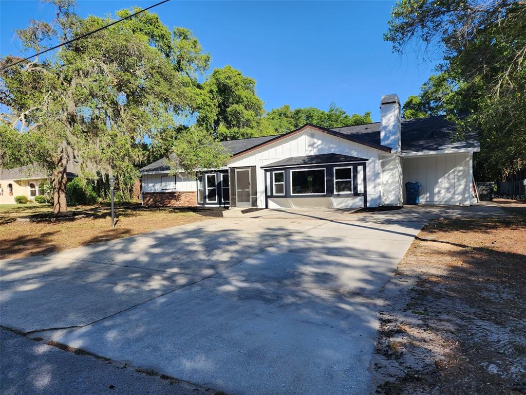 2112 Meadow Lark Road Spring Hill, FL 34608 - Photo 1 of 1 a front view of a house with a yard