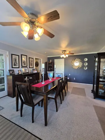 a view of a dining room with furniture and chandelier