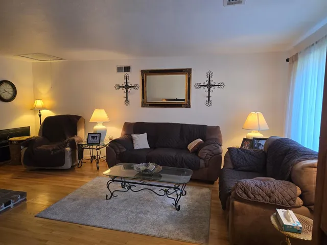a living room with furniture and a lamp