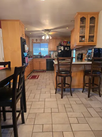 a kitchen with stainless steel appliances kitchen island granite countertop a sink and cabinets