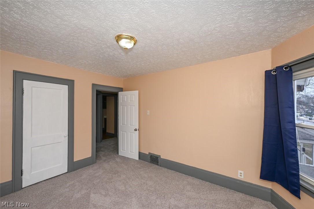 77 West Mildred Avenue Akron, OH 44310 - Photo 30 of 40 Unfurnished bedroom featuring carpet flooring and a textured ceiling