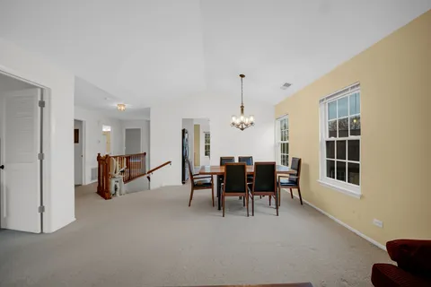 a view of dining room with furniture and chandelier