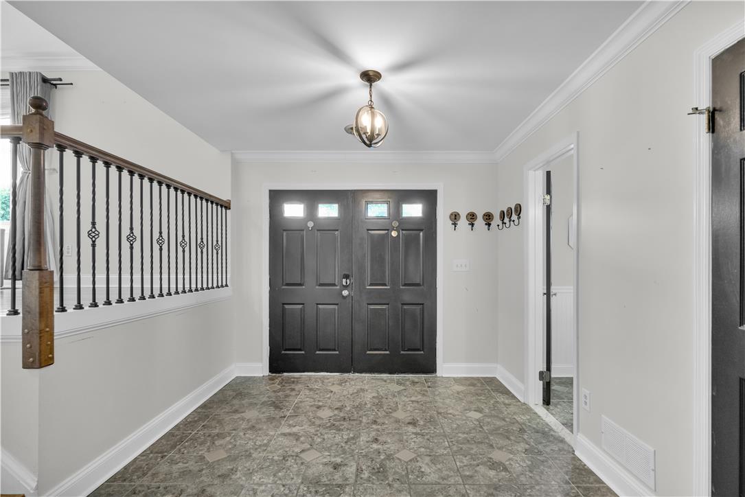 3396 Darien Road Bethlehem, PA 18020 - Photo 7 of 44 A well-lit entry with tiled flooring welcomes guests, offering a glimpse of the elegant staircase.