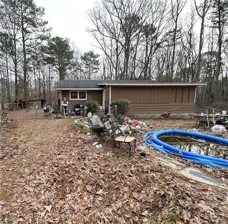 258 Tyson Road Villa Rica, GA 30180 - Photo 1 of 1 a view of a wooden house with large trees
