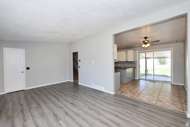 1272 Cook Street Ogden, UT 84404 - Photo 7 of 46 Spacious main living area featuring wood-finish flooring and light gray walls