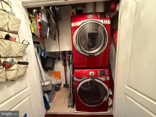 a utility room with dryer washer and a view of kitchen