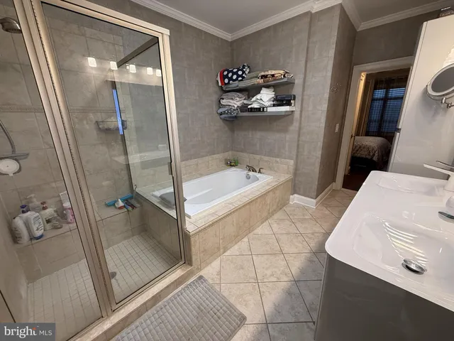 a bathroom with a tub sink and mirror