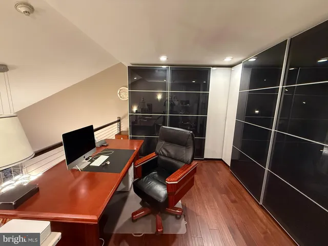 a view of workspace with wooden floor windows