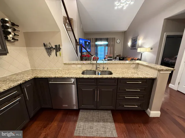 a bathroom with a granite countertop double vanity sink and mirror