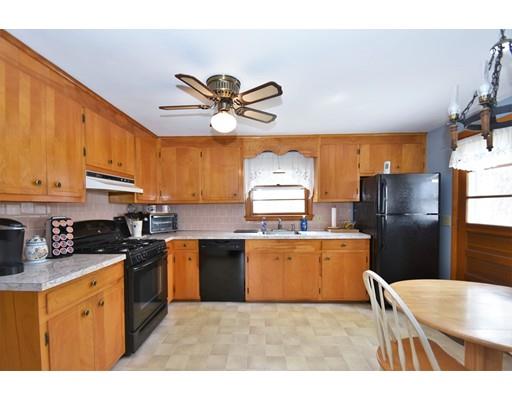 639 Boston Road Billerica, MA 01821 - Photo 2 of 18 a kitchen with stainless steel appliances granite countertop a sink a stove a refrigerator cabinets and a dining table