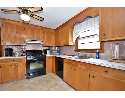 639 Boston Road Billerica, MA 01821 - Photo 3 of 18 a kitchen with stainless steel appliances granite countertop a sink a stove cabinets and a window
