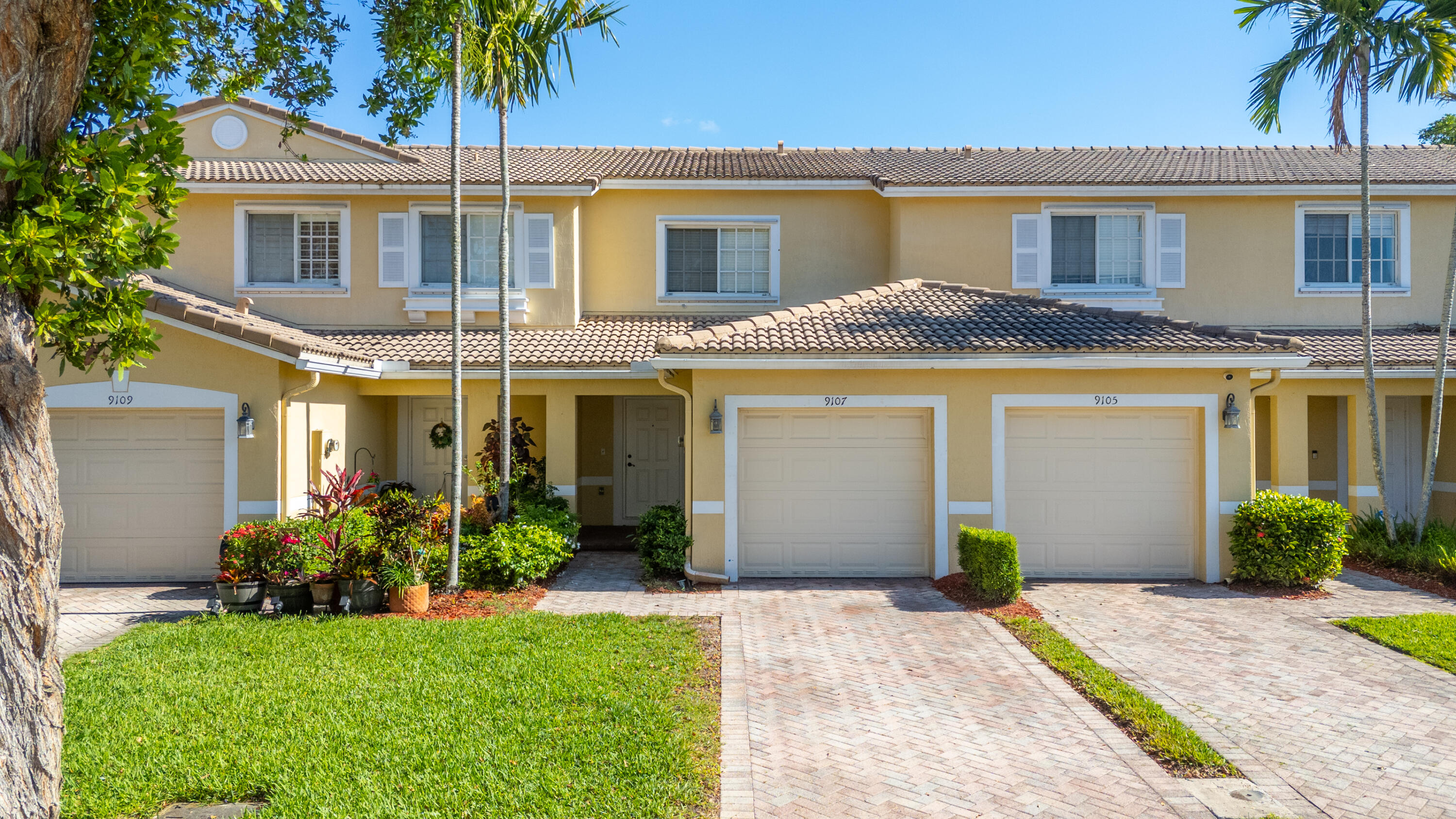 9107 Chambers Street, Unit 9107 Tamarac, FL 33321 - Photo 2 of 30 a front view of a house with garden