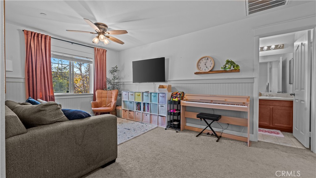 3641 Bur Oak Road San Bernardino, CA 92407 - Photo 11 of 20 a living room with furniture and a flat screen tv