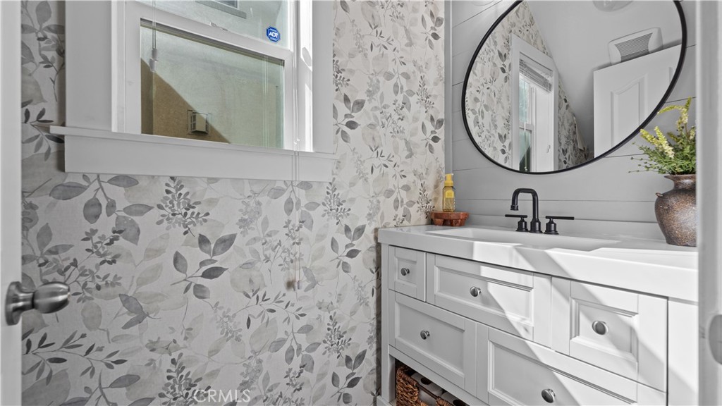 3641 Bur Oak Road San Bernardino, CA 92407 - Photo 12 of 20 a bathroom with a sink and a mirror