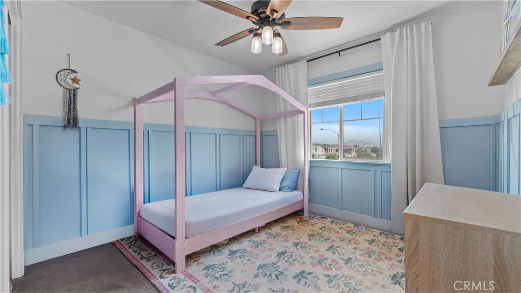 3641 Bur Oak Road San Bernardino, CA 92407 - Photo 15 of 20 a bedroom with a bed and a mirror