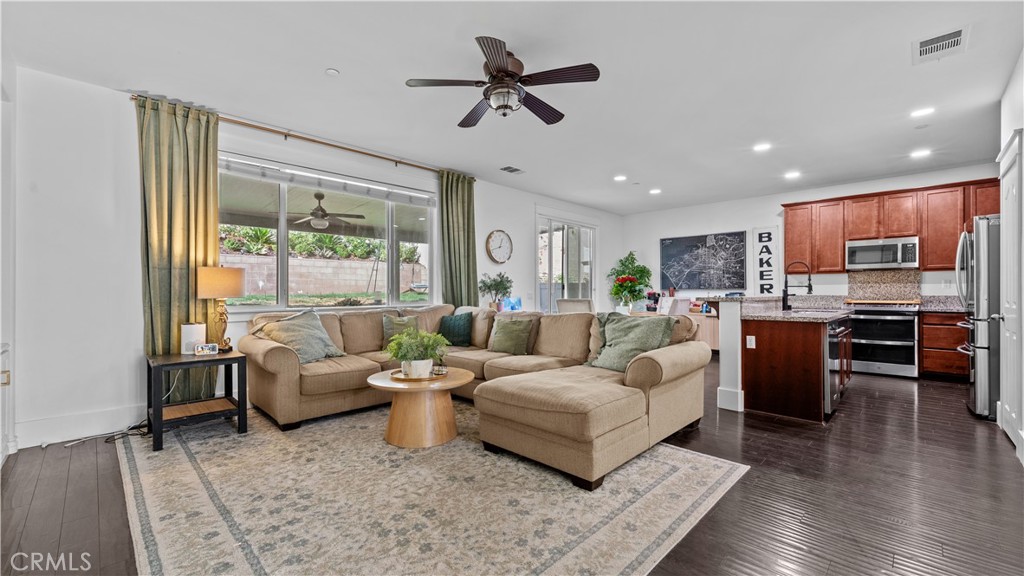 3641 Bur Oak Road San Bernardino, CA 92407 - Photo 3 of 20 a living room with furniture kitchen view and a large window