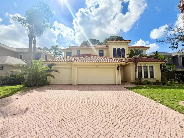 a front view of a house with a garden and pathway