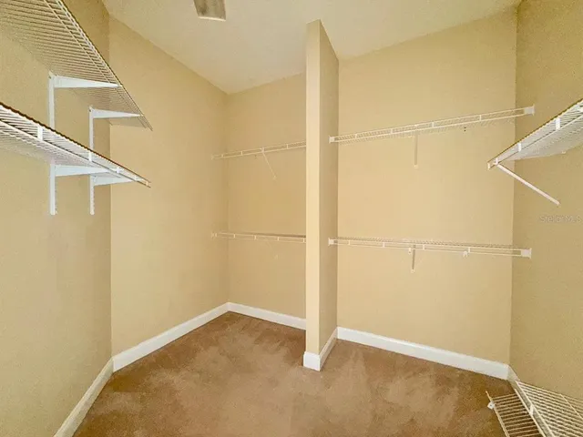 a view of a livingroom with a ceiling fan and window