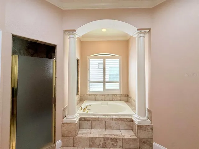 a bathroom with a bathtub and shower