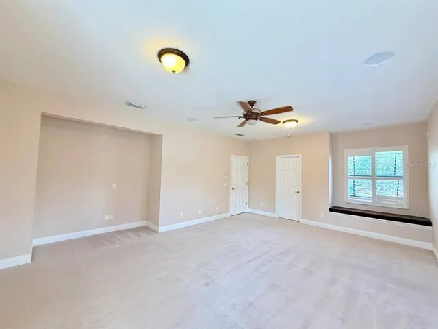 an empty room with wooden floor and window