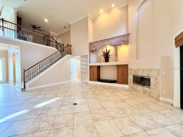 a view of a living room and kitchen with stainless steel appliances